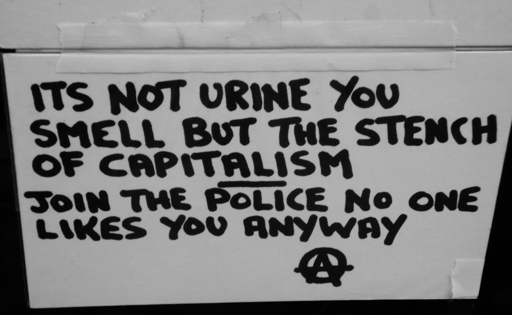 Political street graffiti gives a scathing critique of capitalism and modern day America.